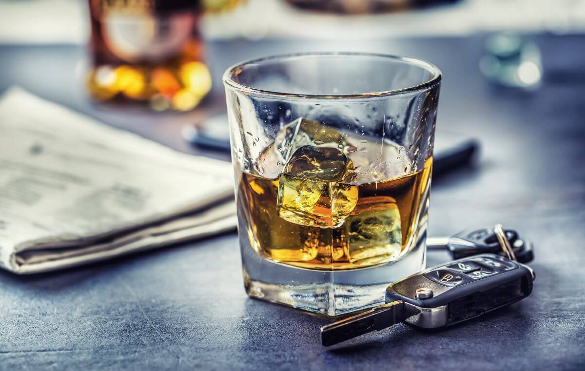 Alcoholic drink on a glass with ice and car keys